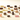 An assortment of various chocolates and truffles, including squares, domes, and pieces with different coatings, arranged neatly on a light surface.