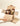 An open cardboard box containing assorted Venchi chocolates and treats sits on a white surface. A hand reaches toward the box, and a brown padded envelope lies nearby. - AI generated text