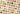 Assorted colorful wrapped and unwrapped chocolates are arranged in a diagonal grid on a light beige background, with some chocolates cut open and pieces of fruit and nuts scattered among them. - AI generated text