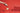 A hand pours dark granules from a jar onto a small dessert placed on a gold tray, set against a bright red background with geometric red platforms. - AI generated text