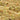 Close-up of a slab of pistachio nougat, showing creamy beige nougat embedded with whole and chopped green pistachio nuts. - AI generated text