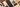 Assorted chocolate bars, including dark, milk, and white varieties, arranged neatly on a light beige surface. The bars have different textures and patterns, with some containing visible inclusions like nuts or fruit pieces. - AI generated text