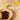 A plate with two dark chocolate bars sits next to a cocktail glass filled with a light yellow drink, garnished with a lime slice. A halved lime rests nearby on a light-colored surface. - AI generated text