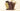 Four chocolate bars in different colors stand upright behind a pile of chocolate pieces. The center bar has Venchi embossed and a geometric pattern, while the others have Venchi embossed on each square. - AI generated text