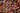 A close-up view of a pile of dried cocoa beans, showing their rough, textured brown surfaces and natural variations in color. - AI generated text