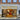 Storefront of Venchi, an Italian chocolate and gelato shop, with large glass doors, gold signage, and displays of chocolates and ice cream inside. Two large decorative ice cream cones are outside the entrance. - AI generated text