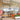 A modern Venchi gelato shop with glass walls, orange chairs, and decorative ice cream cone designs. People are inside near the counter, and a colorful sign is displayed at the entrance. - AI generated text