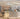 A modern Venchi chocolate store interior features elegant white decor, shelves stocked with chocolates, a display of assorted treats, and an ice cream counter with cones. The atmosphere is bright and inviting. - AI generated text