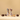 Two wrapped nougatine candies stand upright between three oval-shaped chocolate-covered sweets, with one cut open to reveal a nut-filled center, all set against a beige background. - AI generated text