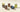 Five jars of Venchi spreads are arranged on a light surface. The jars have various colored labels and lids, including gold, brown, green, and blue, and contain different flavors of chocolate and pistachio spreads. - AI generated text