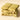 The Pistachio Gourmet Bars Bundle features four pale green chocolate bars stacked together, each filled with whole pistachios and engraved with a letter—an ideal aperitif snack on a plain beige surface.