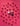 Raspberries are arranged in a grid pattern on a pink background, with a wrapped chocolate, a half-unwrapped chocolate, and a chocolate square covered in sprinkles placed near the center. - AI generated text