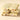 The White Salted Bars Bundle features three stacked white chocolate squares with Piedmont hazelnuts, dried fruits, and salted whole nuts for texture. Embossed letters top each piece, set against a plain light beige background.